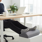 Person working with footrest at desk